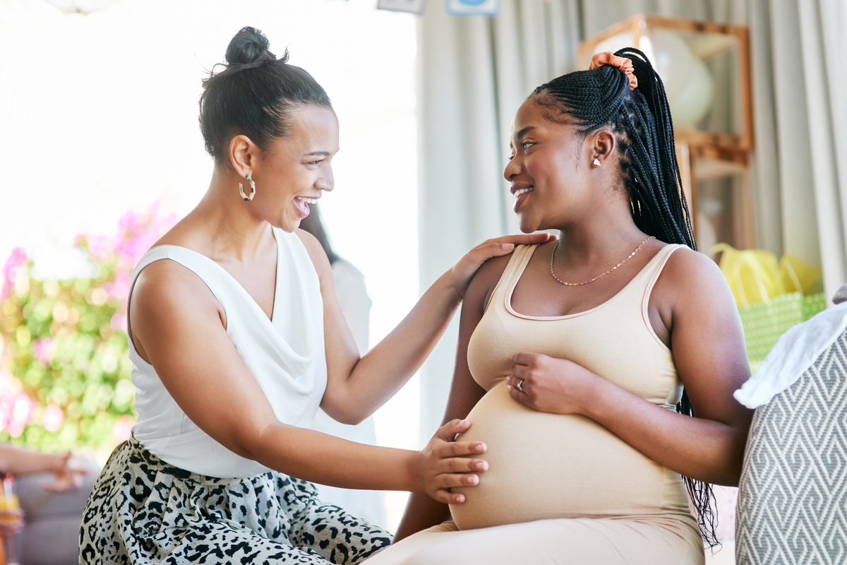 Doula supporting a pregnant mother during a prenatal visit