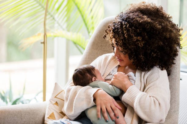 Mother breastfeeding her baby during a postpartum visit